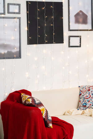 White sofa with plaid and cusion close up shotの写真素材