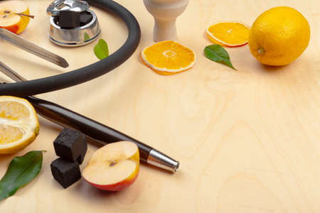 Parts of hookah and fruits on wooden background