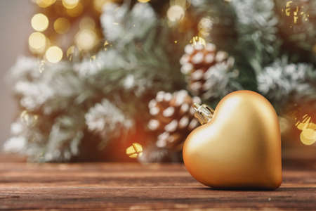 Christmas decorative balls against blurred pine tree backgroundの写真素材