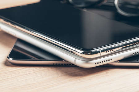 Digital tablet and mobile phone. Electronic devices on wooden table, close up.の写真素材