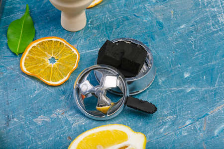 Parts of hookah and fruits on wooden backgroundの写真素材