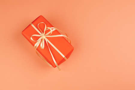 Present with a bow on orange backgroundの写真素材