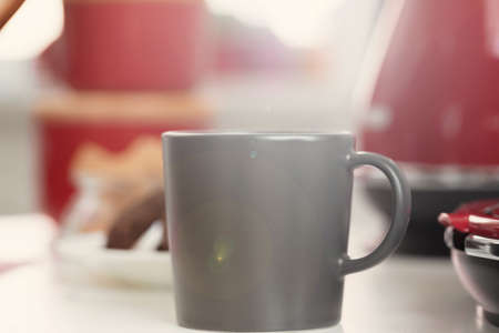 Cup of tea or coffee on modern kitchen backgroundの写真素材