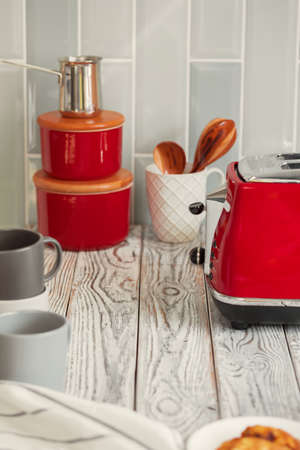 Kitchen shelf with red utensils and dishwareの写真素材