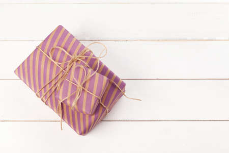 Tied bows gift boxes on white wooden background, top viewの写真素材