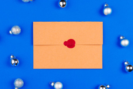 Desk with envelope and Christmas decorations. Flat lay. Mockupの写真素材