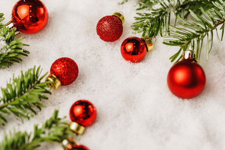 Snowy table with christmas bauble decoration close up