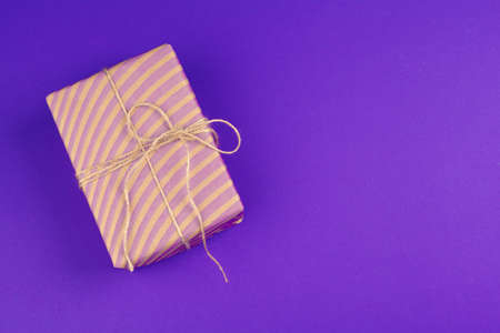 Gift box on purple background top viewの写真素材