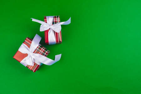 Decorated gift box on a green background, flat lay top viewの写真素材