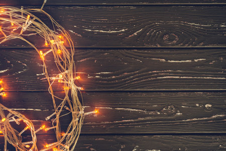 Christmas garland on wooden background with copy space