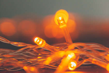 Illuminated garland close up on dark backgroundの写真素材