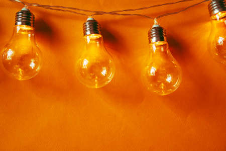 Beautiful illuminated festive light bulbs garland close up