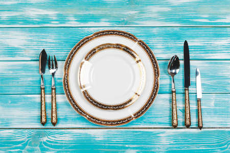 Beautiful table setting on blue wooden backgroundの写真素材