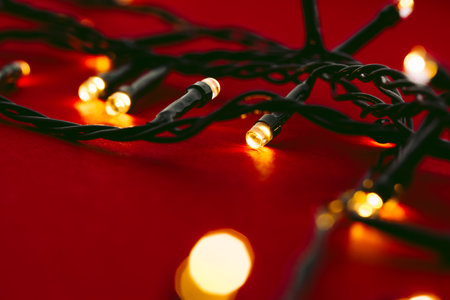 Red background with illuminated lights of garland