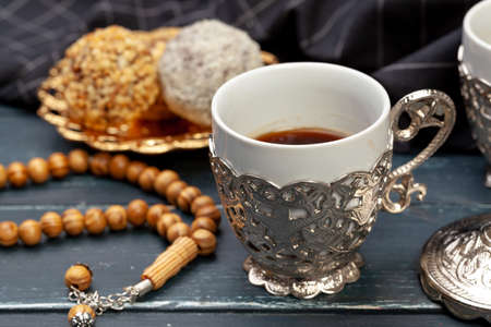 Nut balls dessert served with coffee on dark wooden table, top viewの写真素材