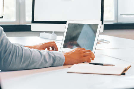 Unrecognizable man working in a modern officeの写真素材