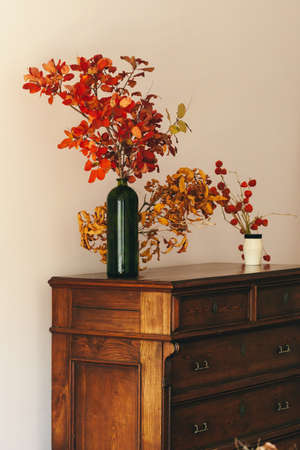 Autumn interior decoration with dry bouquet on wooden tableの写真素材