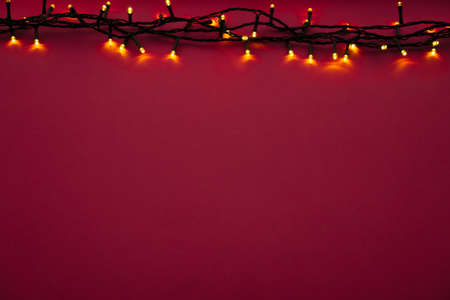 Illuminated garland lights on bright pink backgroundの写真素材