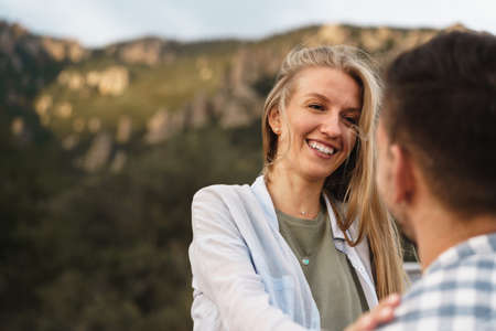 Happy couple man and woman tourists in mountainsの写真素材