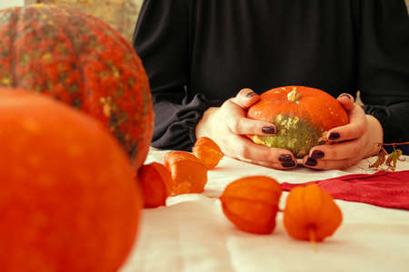 Cropped image of a woman holding a pumpkin in her handsの写真素材