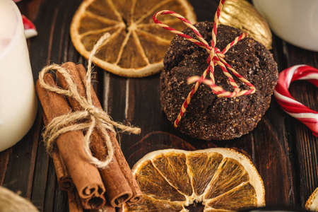 Oatmeal cookies on a old wooden background with cinnamon sticks and decorationsの写真素材