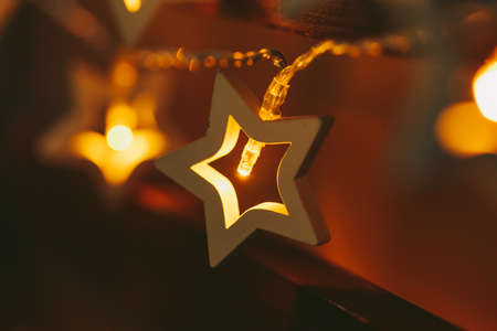 Beautiful bokeh light of star shaped garland in the darkの写真素材