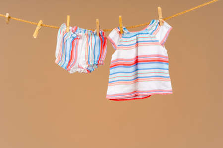 Kids apparel pinned to a clothesline to dryの写真素材