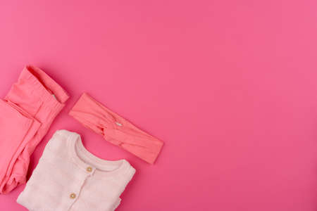 baby clothes on pink background top viewの写真素材