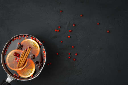 Top view of hot mulled wine and spices on black backgroundの写真素材