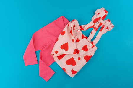 Top view of baby clothes on blue backgroundの写真素材