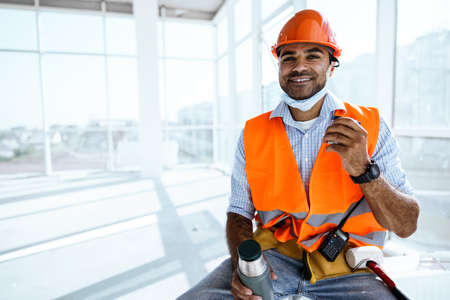 Portrait of a man worker in workwear on a break drink coffee and have restの写真素材