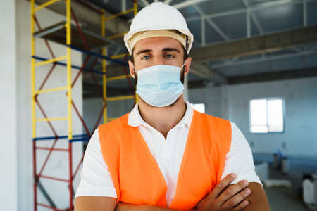 Portrait of young construction engineer wearing hardhat