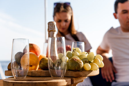 Fruit tray and bottle of champagne for romantic date on a yachtの写真素材
