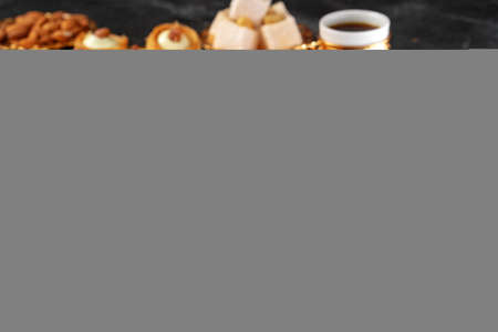 Turkish dessert baklava with a cup of coffee on black backgroundの写真素材