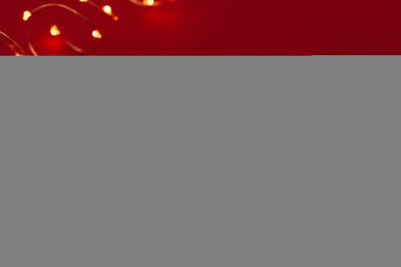Red background with illuminated lights of garlandの写真素材