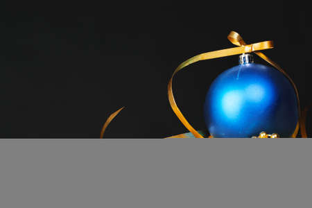 Beautiful christmas bauble close up on a dark red backgroundの写真素材