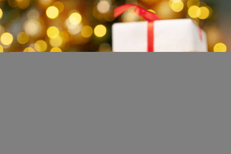 Xmas baubles on wooden table on bokeh backgroundの写真素材