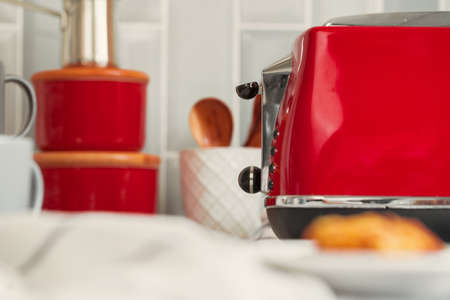 Kitchen shelf with red utensils and dishwareの写真素材