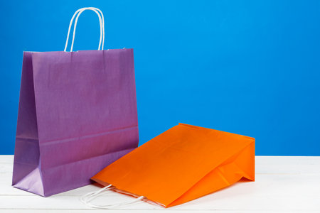 Paper shopping bags with copy space on blue backgroundの写真素材