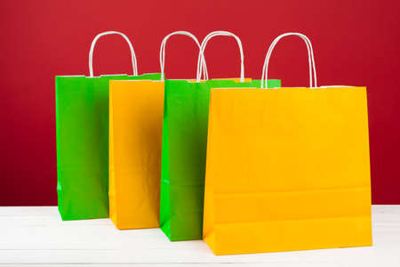 Arrangement of shopping bags on red backgroundの写真素材