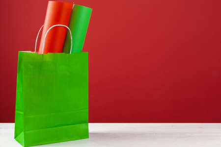 Several shopping bags with copy space on red backgroundの写真素材