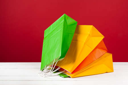 Arrangement of shopping bags on red backgroundの写真素材