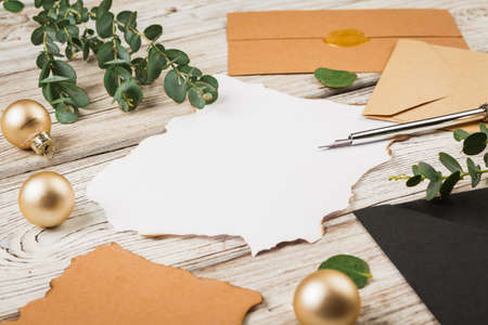 Vintage style composition with weathered paper and quill pen on wooden table close upの写真素材