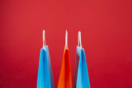 Arrangement of shopping bags on red backgroundの写真素材