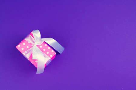 Gift box on purple background top viewの写真素材