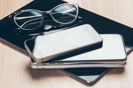 Digital tablet and mobile phone. Electronic devices on wooden table, close up.の写真素材