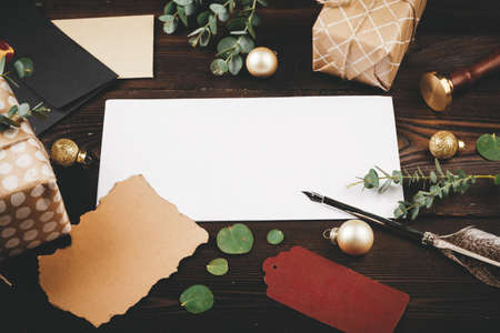 Writing Christmas post on holiday wooden decorated backgroundの写真素材