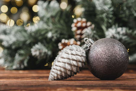 Christmas decorative balls against blurred pine tree background