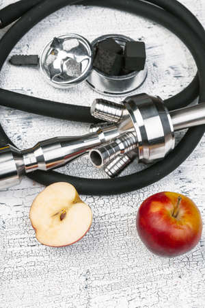 Parts of hookah and fruits on wooden background