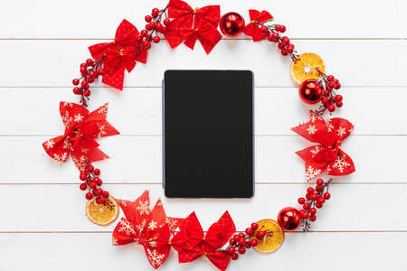 Office table with devices, supplies and christmas decor. View from aboveの写真素材